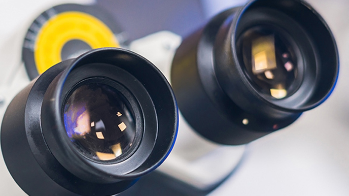 Close-up of a microscope opocular with two lenses showing the challenges of vibration control in nanoscience applications such as scanning probe microscopy and electron microscopy